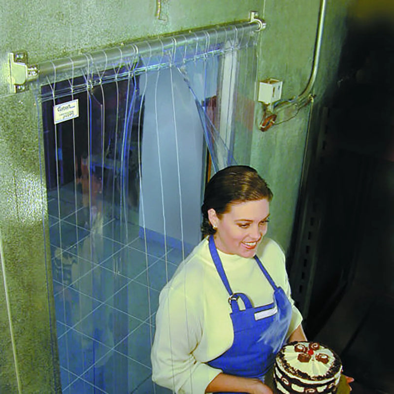 Curtron M-Series clear PVC strip curtain door shown in use at a cooler doorway as a worker carries a cake through