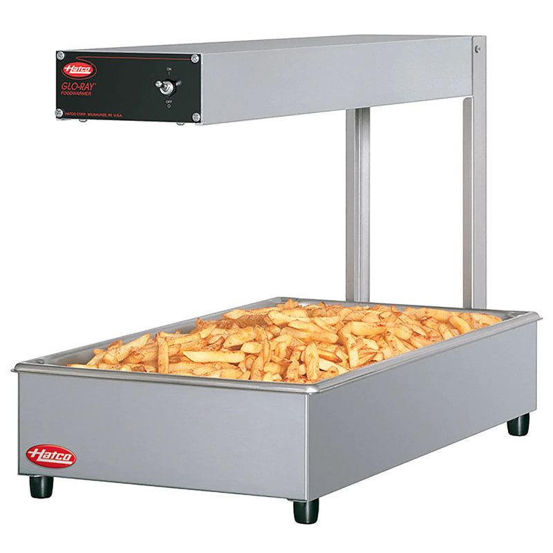 Hatco GRFF countertop chip dump station in stainless steel with overhead heater, shown holding french fries