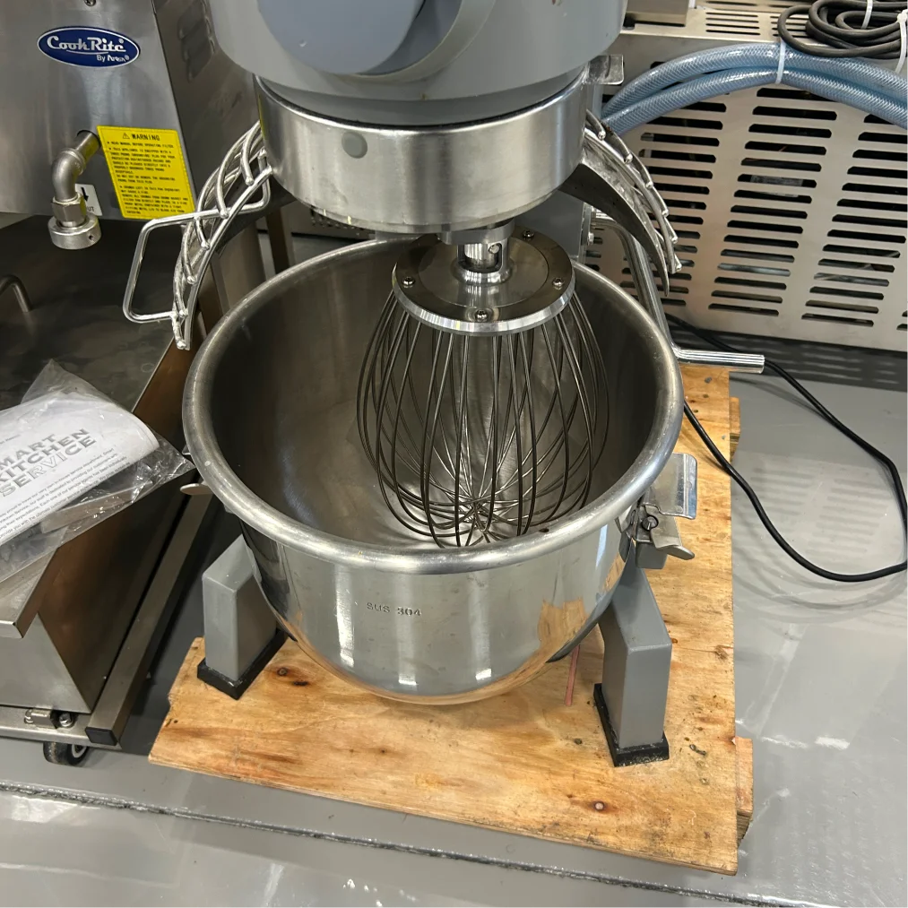 Certified used Alpha AVP-20 20 qt mixer, close-up of the stainless steel bowl with the wire whisk attachment inside
