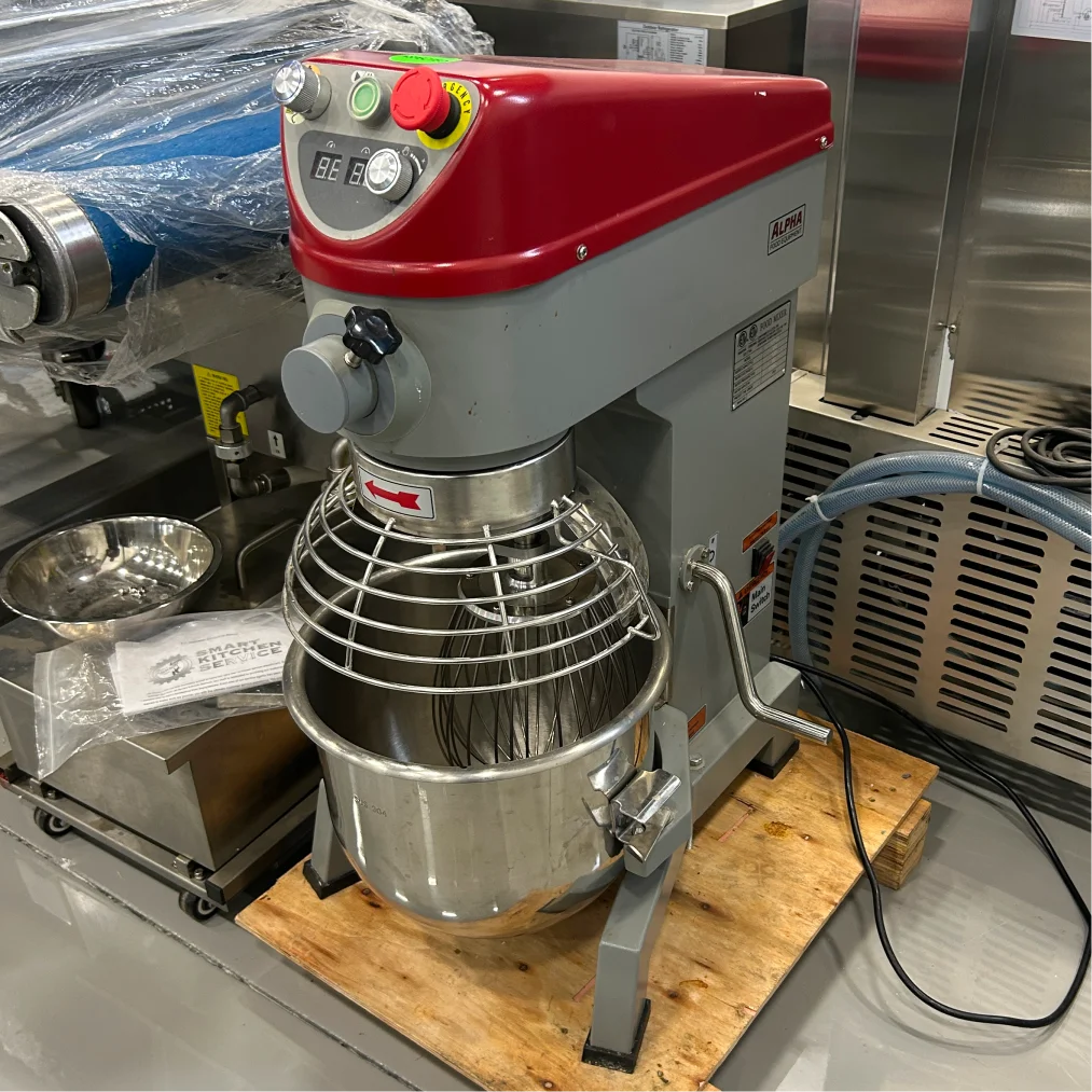 Certified used Alpha AVP-20 20 qt planetary stand mixer on a pallet, angled right view of the grey column and bowl