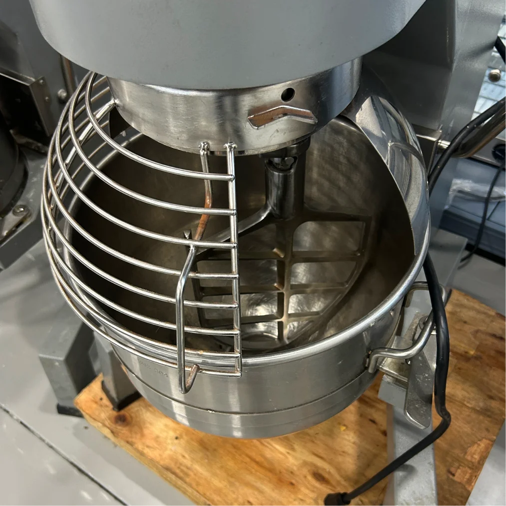 Certified used Alpha AVP-30 30 qt mixer, close-up of the wire bowl guard over the stainless steel mixing bowl
