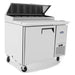 Atosa MPF8201GR 44-inch single door pizza prep table on casters with lid raised, angled view
