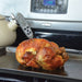 Bios DT131 digital waterproof pocket thermometer in use, probe inserted into a roast chicken on a baking sheet