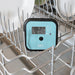 Bios DT137 commercial dishwasher thermometer in use, placed in a dishwasher rack beside plates to check wash temperature