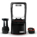 Blendtec Nitro Stealth blender with sound enclosure, shown with black blending chamber and red-rimmed base accessory
