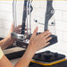 Hamilton Beach HBH855 Summit high performance blender, hands removing the clear sound enclosure from the base