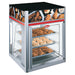 Hatco FSD-X Series glass display pizza/food warmer with fixed pan rack shown holding fried chicken, printed graphics