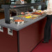 Hatco HWB-4QT round drop-in soup warmer shown in use installed in a buffet serving counter with food