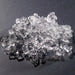 Hoshizaki F-1002MAJ modular ice machine, close-up of a pile of clear flake shaped ice on a dark surface