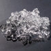 Hoshizaki F-822MAK modular ice machine, close-up of a pile of clear flake shaped ice on a dark surface
