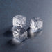 Hoshizaki IM-200BAC ice machine, close-up of clear 1 x 1 inch cube shaped ice on a dark surface