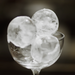 Hoshizaki IM-50BAA-Q ice machine, clear sphere shaped ice balls stacked in a stemmed glass