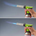 Iwatani CB-TC-CKGR cooking torch in use, hand holding the torch on a gas canister with a blue flame lit