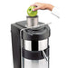 Juicernet ES500 Ceado fruit and vegetable juicer with a green apple being fed into the chute, shown in use
