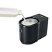 Jura Cool Control 1L milk cooler in black, milk being poured from a bottle into the open stainless steel container