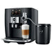 Jura Cool Control 1L milk cooler in black shown beside a Jura coffee machine making a latte macchiato