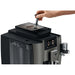 Jura W8 commercial automatic coffee machine, hand adjusting the grinder setting beside the bean container