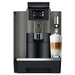 Jura W8 commercial automatic coffee machine in dark inox, front view with a latte macchiato under the milk spout