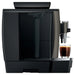 Jura W8 commercial automatic coffee machine, side view showing the water tank with a glass of coffee under the spout