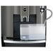 Jura W8 commercial automatic coffee machine, front close-up of the clear milk container and milk tube