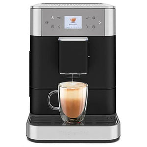 KitchenAid KES8556BK fully automatic espresso machine in black, brewing a latte into a clear glass mug