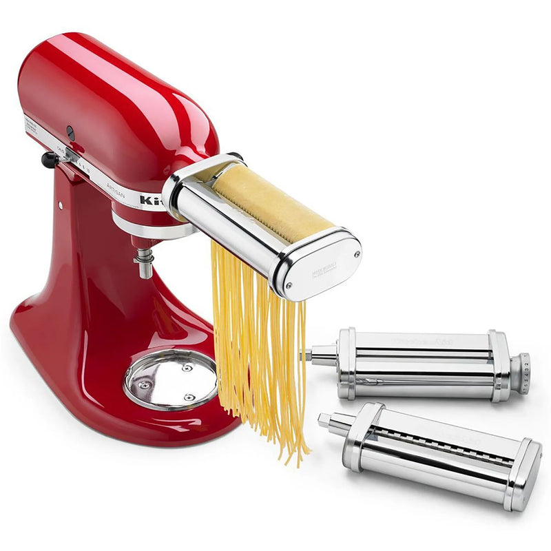 KitchenAid KSMPRA 3-piece pasta roller and cutter set on a red stand mixer cutting fresh fettuccine