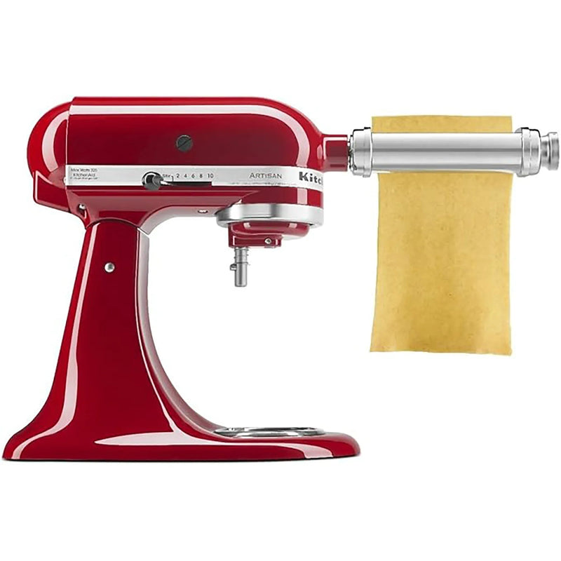 KitchenAid KSMPSA stainless steel pasta roller attachment on a red stand mixer rolling a fresh pasta sheet