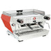 La Marzocco KB90-AV-2-GR two group espresso machine, angled view of the stainless steel body with red side panel