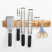 Mercer Culinary 18-inch wooden magnetic knife bar mounted on a wall holding knives, spatula, graters and scissors