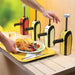 Nemco 10959 in-counter dispensers installed in a counter, shown dispensing condiments beside a plate of food