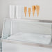 Nordic Air IDF-47 ice cream dipping freezer, close-up of the glass sneeze guard and top shelf holding cones and cups