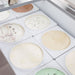 Nordic Air IDF-68 ice cream dipping freezer, close-up of the tub wells filled with assorted ice cream flavours