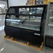 Open box Beverage Air CDR5HC-1-B 60-inch curved glass deli case in black on a warehouse pallet, left side angle
