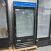 Open box Nordic Air GFM-26 black glass door display freezer with blue header, front view in the warehouse