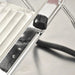 Omcan 13659 mandoline slicer, close-up of the stainless steel cutting platform and black adjustment knob