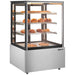 Omcan 48390 35-inch square glass floor display warmer with 3 shelves stocked with pastries, angled view