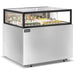 Omcan 48562 48-inch stainless steel flat top refrigerated pastry showcase stocked with cakes and desserts, angled view