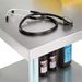 Phoenix ECONOMY 18 gauge stainless steel work table shown in use with supplies stored on the undershelf