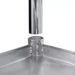 Phoenix ECONOMY 18 gauge stainless steel work table, leg being lowered into the undershelf corner socket