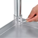 Phoenix PREMIUM 16 gauge stainless steel work table, close-up of a hand tightening the leg set screw
