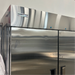 Open box Nordic Air SR-54 refrigerator, close-up of the stainless steel top header with the Nordic Air logo