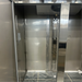 Open box Nordic Air SR-54 refrigerator, close-up inside the left section showing the shelf standards and evaporator