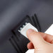 San Jamar R4000TBK jumbo toilet tissue dispenser, close-up of a hand inserting the white plastic key into the cover lock