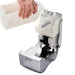 San Jamar S900TBK manual soap dispenser with cover open, hand pouring liquid soap into the white refillable reservoir