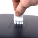 San Jamar T1100TBK paper towel dispenser, close-up of a hand inserting the white plastic key into the top of the cover