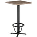 Tarrison APTFTRNGBL Core Collection foot ring in black installed on a bar height table base with wood-look top