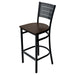 Tarrison Aria bar stool with black metal frame, slotted back, footrest and dark walnut wood seat, angled view
