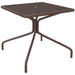 Tarrison Maddox all-weather square mesh table in bronze brown with umbrella hole and splayed tubular legs, angled view
