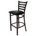 Tarrison Spencer ladder back bar stool with dark walnut metal frame, footrest ring and black vinyl seat