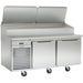 Traulsen TS072HT 72-inch pizza prep table with stainless steel lids raised over the refrigerated pan rail